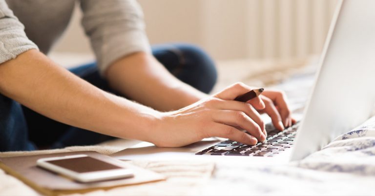 business woman typing on laptop